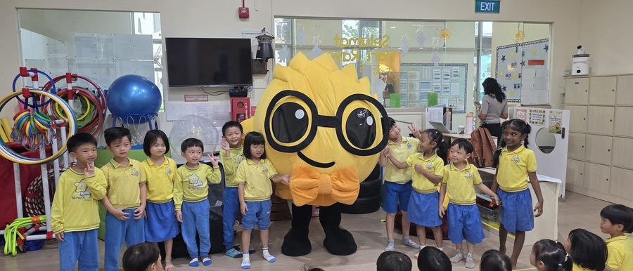 Children posing with the Puffy mascot character at Edufarm Mascot Factory