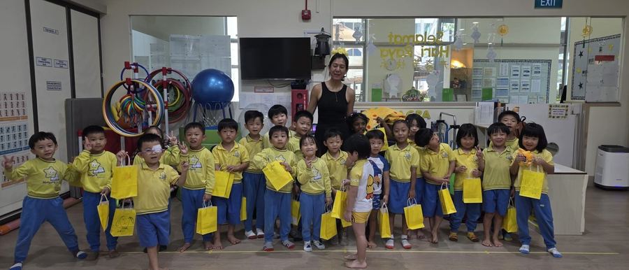 Children holding their finished Mascot Factory goody bags with teacher