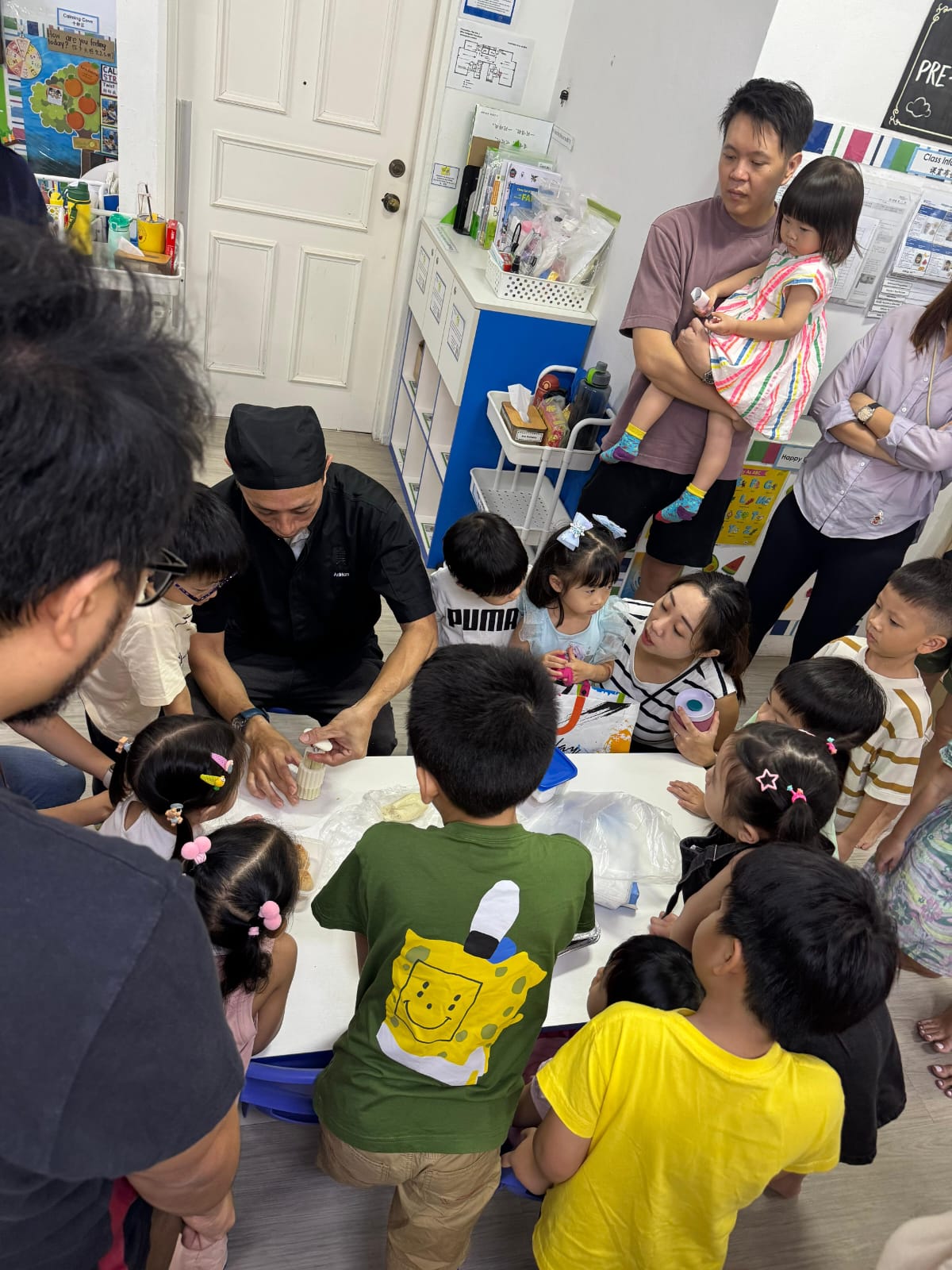 Chef Adrian demonstrating mooncake moulding to children at an Edufarm workshop