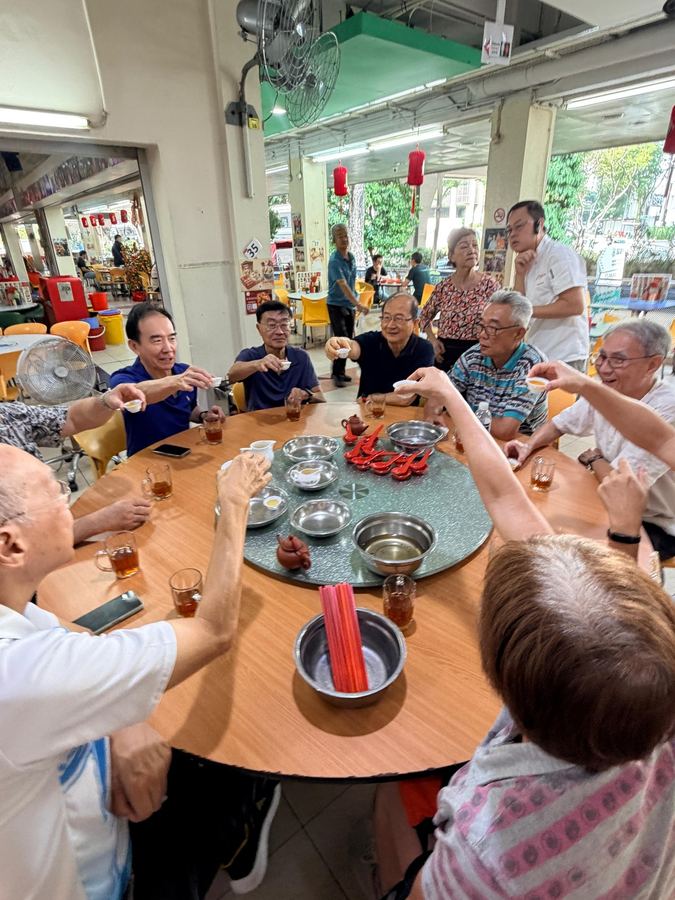 Seniors toasting with tea cups at Ya Hua Bak Kut Teh