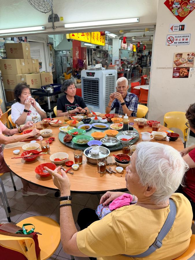 Happy seniors sharing a heritage meal at Keppel Road