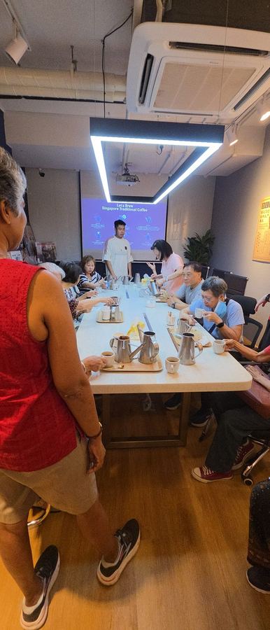 Senior learning about traditional kopi at heritage coffee roastery