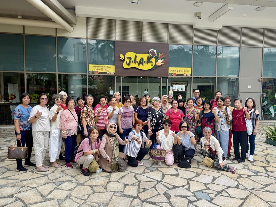 Large group of seniors outside JIAK99 Heritage Hawker Experience at Singapore Flyer
