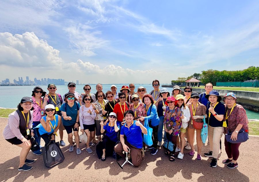 Seniors enjoying the sea breeze and views on yacht trip