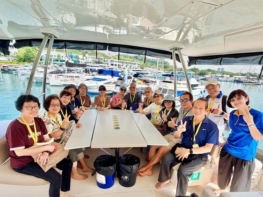 Group of seniors relaxing on private yacht to Lazarus Island